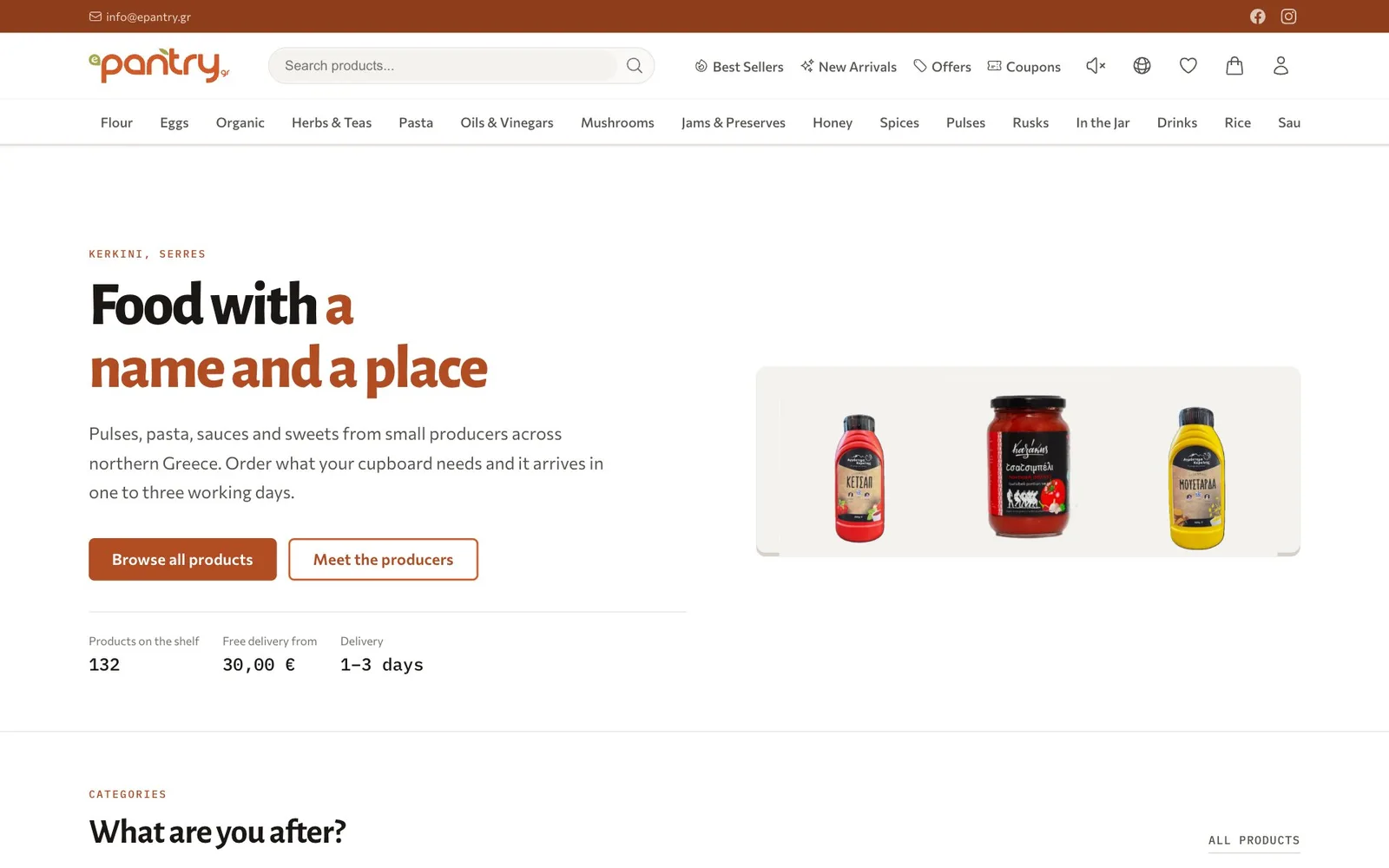 The ePantry home page: a rust-coloured bar with the email address and social icons, the ePantry logo, a product search field, links to Best Sellers, New Arrivals, Offers and Coupons and icons for sound, language, wishlist, bag and account, and a row of categories from Flour to Rice that runs off the right edge; below, the label "Kerkini, Serres", the heading "Food with a name and a place" with its second half in rust, a short introduction, a filled "Browse all products" button and an outlined "Meet the producers" button, and figures for 132 products on the shelf, free delivery from 30,00 € and delivery in 1–3 days, beside a panel of three products: a ketchup bottle, a jar of tsatsibeli sauce and a mustard bottle; the heading "What are you after?" starts below.