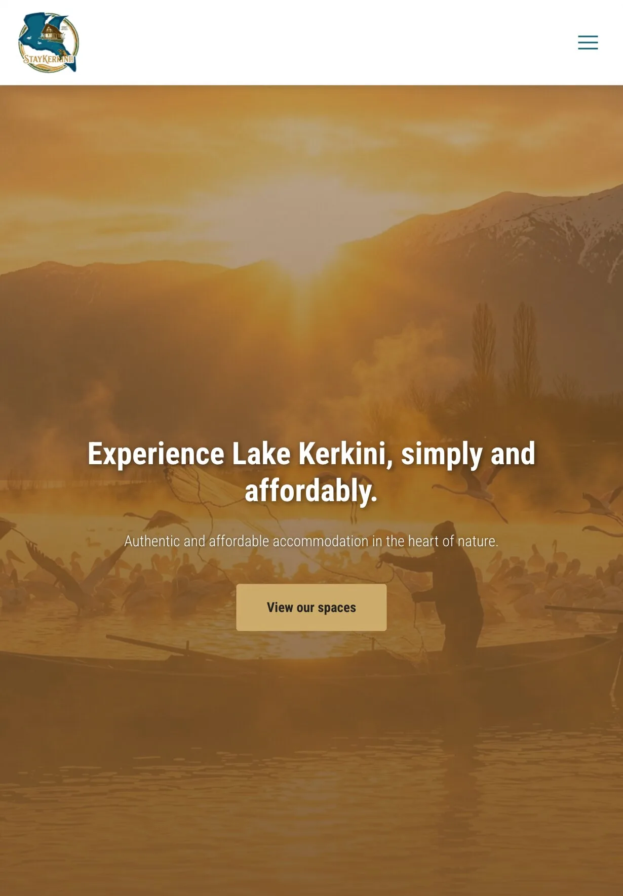 The home page on a tablet: the logo and a menu button above the amber-tinted lake photograph, with mist over the water, a person handling a net in a boat and birds taking off around it; the headline, the line about authentic and affordable accommodation and the gold "View our spaces" button sit in the lower half.