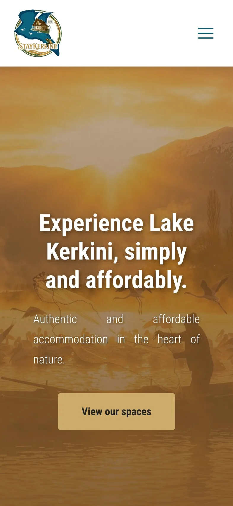The home page on a phone: the logo and a menu button, then the headline "Experience Lake Kerkini, simply and affordably." over three lines, the line about authentic and affordable accommodation over three more, and the gold "View our spaces" button, on the amber-tinted photograph of a person in a boat among birds.